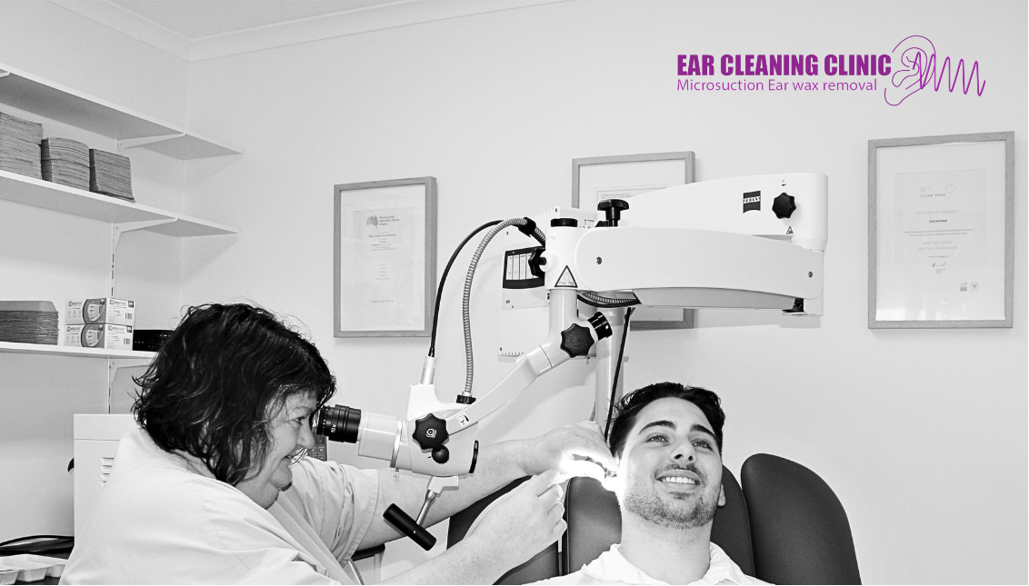 RN Tracy conducting an microsuction ear cleaning on a male patient