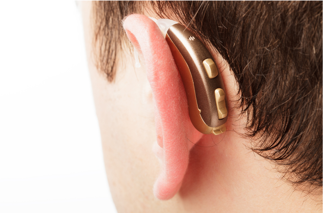 Hearing aid attached to a man's ear
